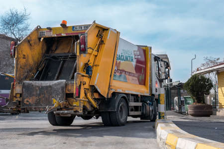 Eminonu, Istanbul, Turkey - 02.18.2021: yellow municipality garbage truck parked in bus depot of...