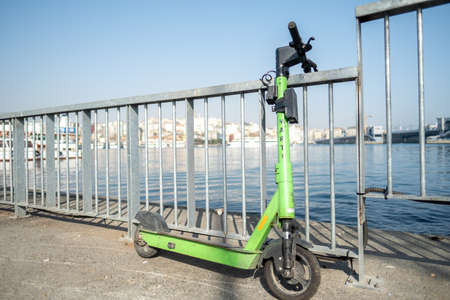 Eminonu, Istanbul, Turkey - 02.27.2021: green scooter parked near Marmara Sea, belonging to electric scooter rental company Marti (Seagull) with copy spaceのeditorial素材