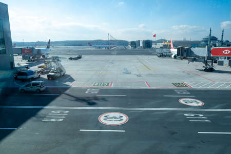 Arnavutkoy, Istanbul, Turkey - 03.08.2021: a lot of Turkish Airlines airplanes in a row and airdrome support vehicles helping in Istanbul Airport in a cloudy airのeditorial素材