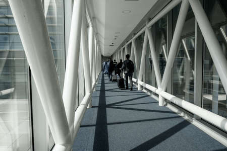 Arnavutkoy, Istanbul, Turkey - 03.08.2021: several male passengers with luggage and bags walking to get in the airplane in Istanbul Airportのeditorial素材