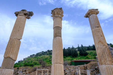 Selcuk, Izmir, Turkey - 03.09.2021: three columns of Memmius Monument in Ephesus ruins, historical...