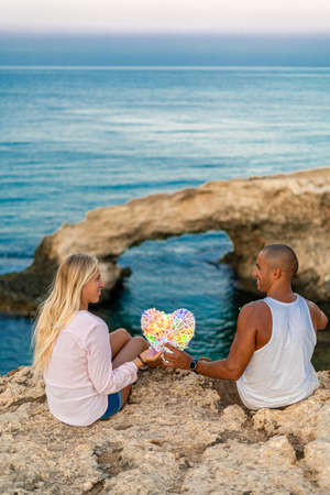 Young Couple in love at bridge of love in Ayia Napa, Cyprus, smiling, laughing. Kisses and love.の写真素材