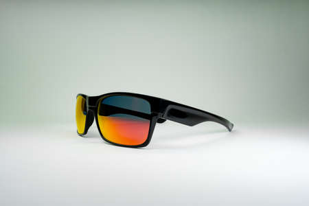 Product photo of sun Glasses with orange glass and black frame on white background. Template for social media, websiteの写真素材