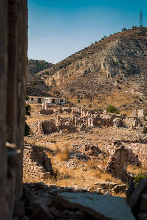 Old Abandoned Ruins of Foinikas Village in Cyprus, located on the green lakeの写真素材