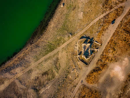 drone aerial photo of old ruined abandoned church in Cyprus Limassol near blue lakeの写真素材