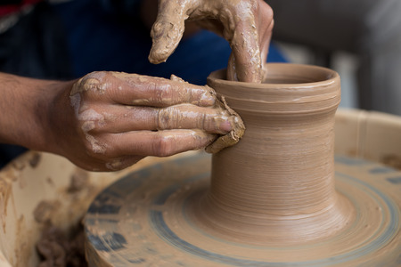 Old potter creating a new ceramic potの写真素材