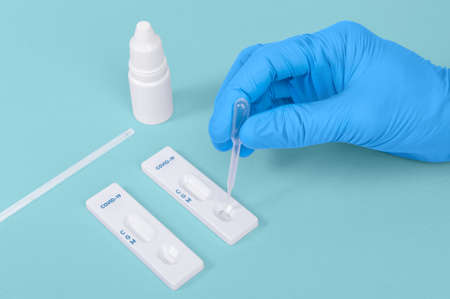 scientist or doctor hand using Rapid antigen test cassette quick fast testing identifying antibodies...