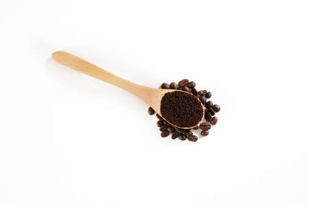 brown roasted coffee beans and coffee cup