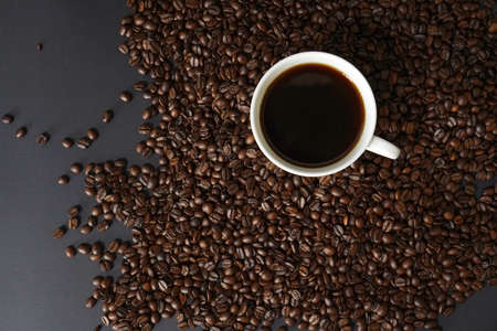 brown roasted coffee beans and coffee cupの写真素材