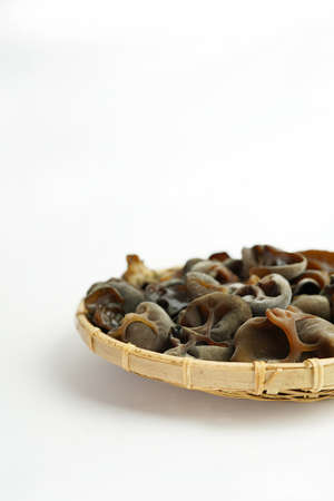 Fresh wood ear nushroom on white background,raw material for cooking. Close up.