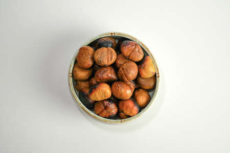 roasted chestnuts on a white background, winter