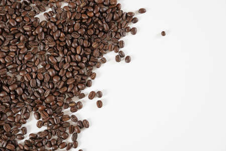 brown roasted coffee beans and coffee cupの写真素材