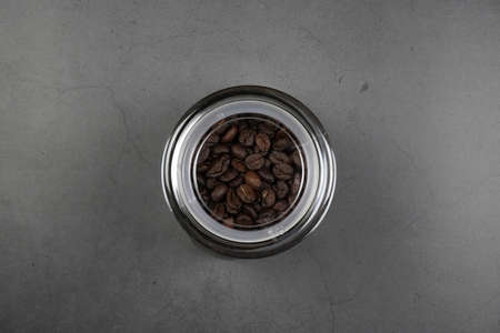 brown roasted coffee beans and coffee cupの写真素材