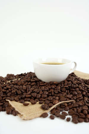 brown roasted coffee beans and coffee cupの写真素材