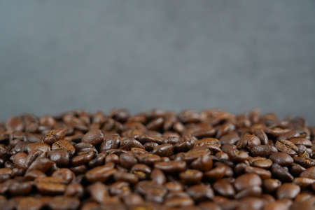 brown roasted coffee beans and coffee cupの写真素材