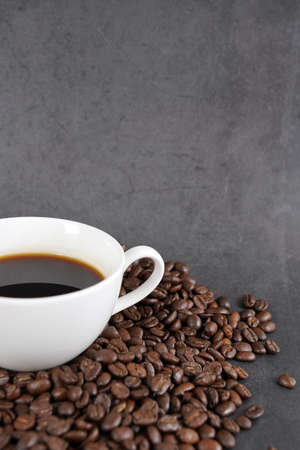 brown roasted coffee beans and coffee cupの写真素材