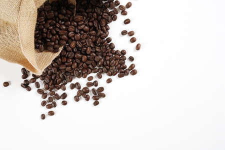 brown roasted coffee beans and coffee cupの写真素材