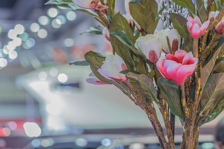 Plastic flowers, pink and white background.の写真素材