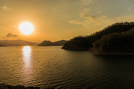 Beautiful landscape during sunset over a mountain ranges at lake in Srinakarin Dam, Kanchanaburi Province, Thailandの写真素材