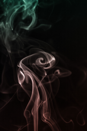 colorful smoke on dark backgroundの写真素材