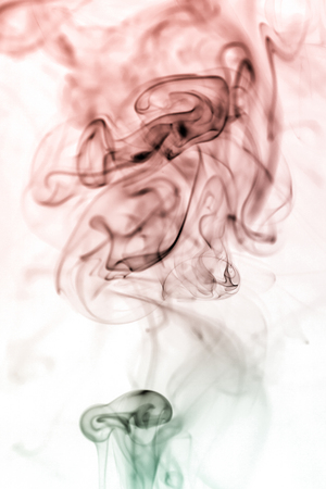 colorful smoke on dark backgroundの写真素材