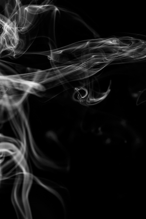 colorful smoke on dark backgroundの写真素材
