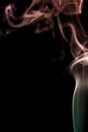 colorful smoke on dark backgroundの写真素材
