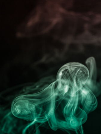 colorful smoke on dark backgroundの写真素材