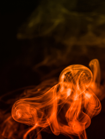 colorful smoke on dark backgroundの写真素材