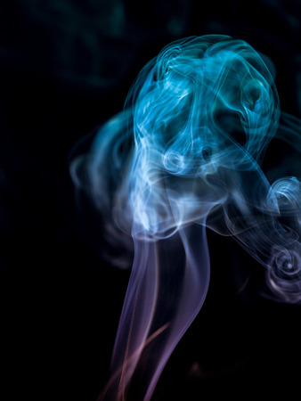 colorful smoke on dark backgroundの写真素材