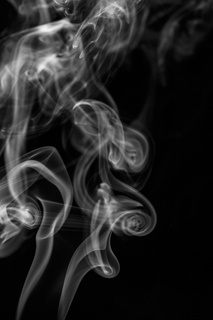 colorful smoke on dark backgroundの写真素材