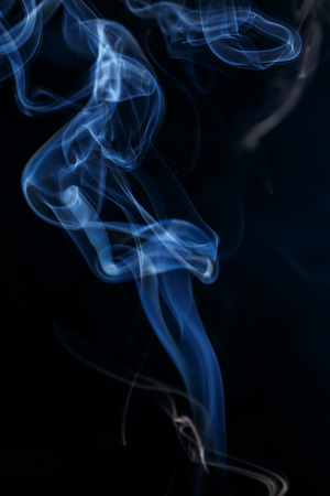 colorful smoke on dark backgroundの写真素材