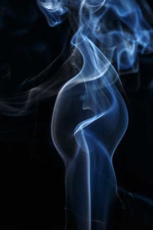 colorful smoke on dark backgroundの写真素材