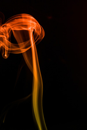 colorful smoke on dark backgroundの写真素材