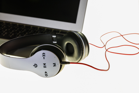 White wireless headphones placed on laminated white backgroundの写真素材