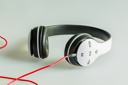White wireless headphones placed on laminated white background