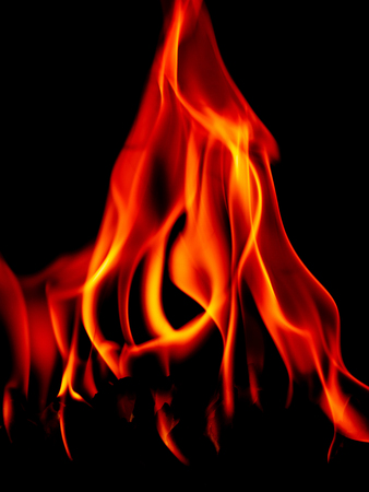 Real fire line flames isolated on black background. Mockup fire wall.の写真素材