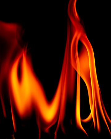 Real fire line flames isolated on black background. Mockup fire wall.の写真素材