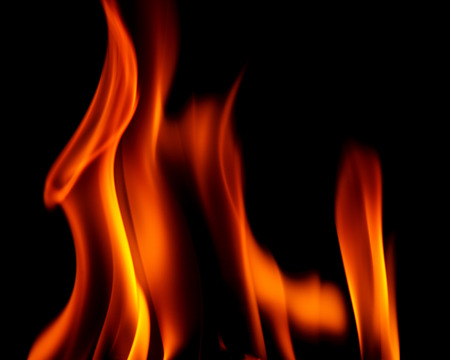 Real fire line flames isolated on black background. Mockup fire wall.
