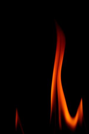 Real fire line flames isolated on black background. Mockup fire wall.