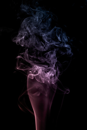 colorful smoke on dark backgroundの写真素材