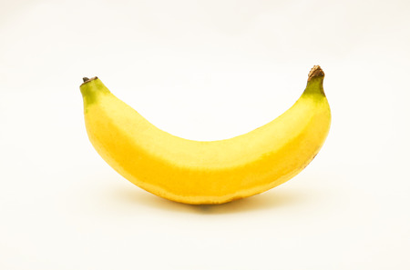 Yellow ripe banana on white background, isolated, it's curvedの写真素材