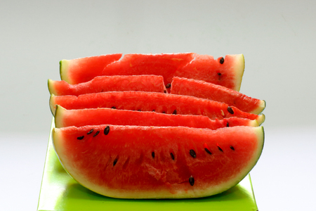 sliced red watermelon on green boxの写真素材