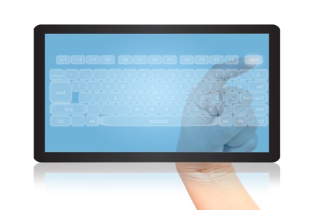 Hand pressing keyboard on tablet isolate on the white.