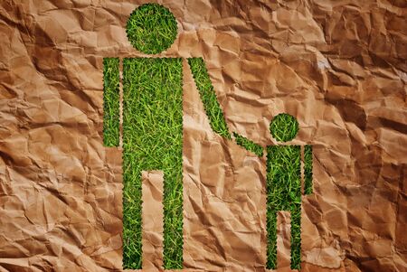 Vintage man and child symbol on the grass field.の写真素材