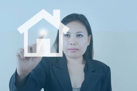 Business lady pressing home icon.の写真素材