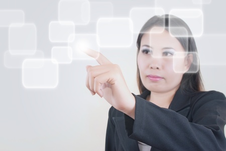 Asian business lady pushing button.の写真素材