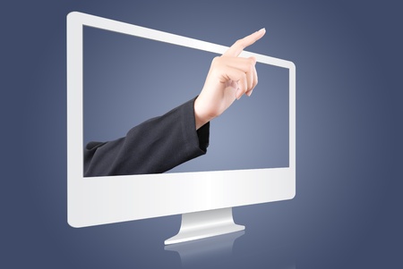 Hand pushing button from monitor screen.の写真素材