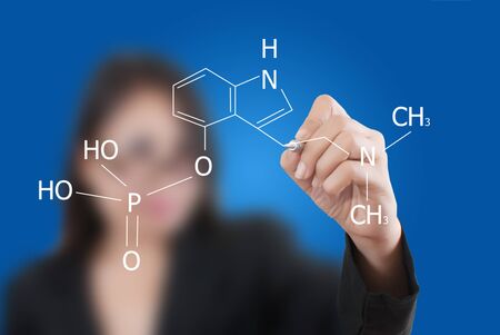 Asian teacher lady writing scientific formula on the whiteboard.の写真素材