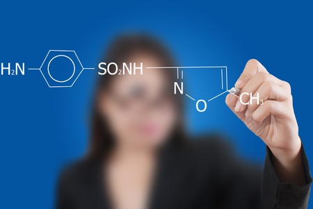 Asian teacher lady writing scientific formula on the whiteboard.の写真素材